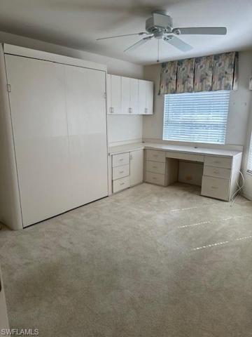 Guest bedroom, currently being utilized as a study/den with built in murphy bed, cabinetry & desk.