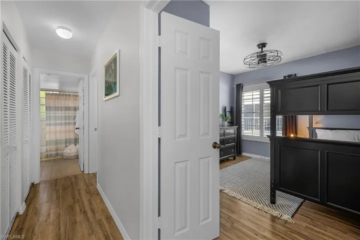 Hallway with baseboards and dark wood finished floors