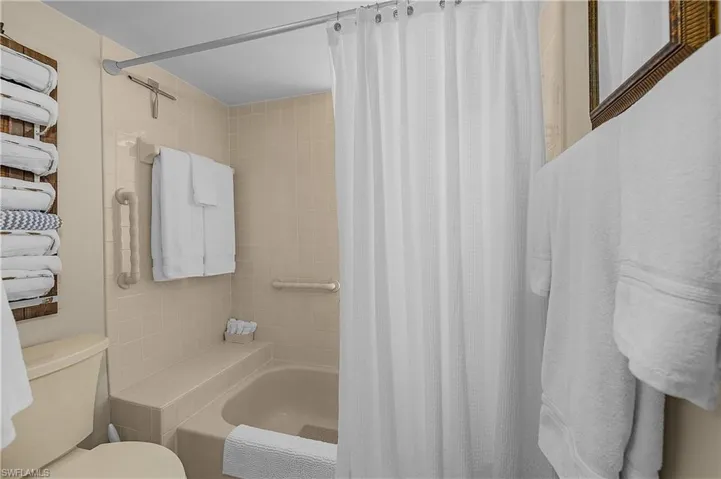 Bathroom with toilet and shower / tub combo