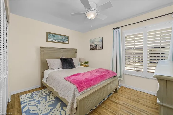 Bedroom with wood finished floors and ceiling fan