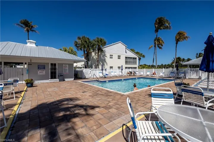 Community pool with a patio area, outdoor dining area, and a gazebo