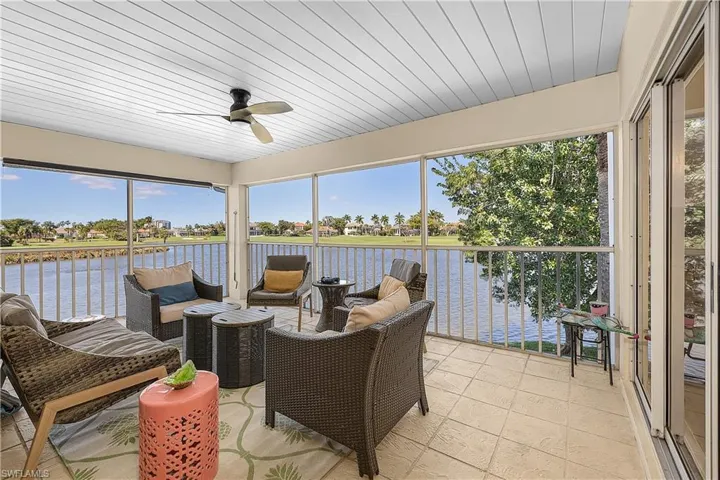 Sunroom / solarium featuring a ceiling fan, an outdoor lounge area, and a water view