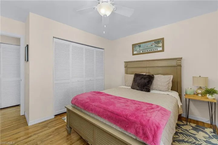 Bedroom with a closet, light wood-style floors, and ceiling fan