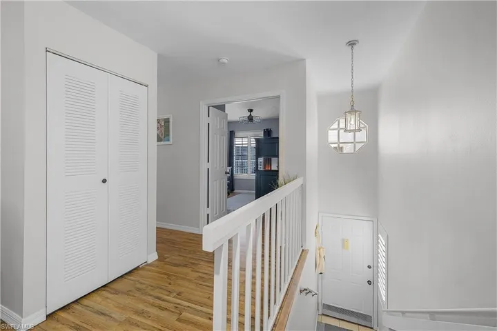 Foyer entrance with light wood-style floors and baseboards