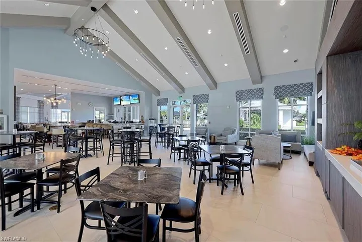 Dining space with beam ceiling, high vaulted ceiling, a chandelier, healthy amount of natural light, and recessed lighting