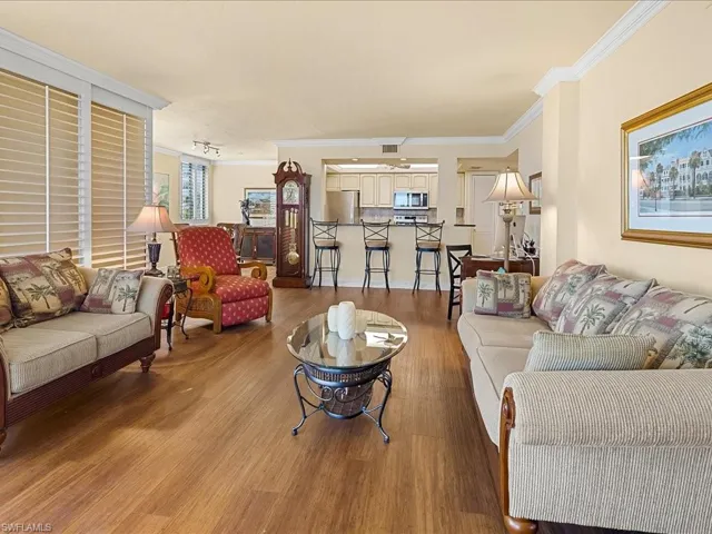 Living area featuring crown molding and wood finished floors