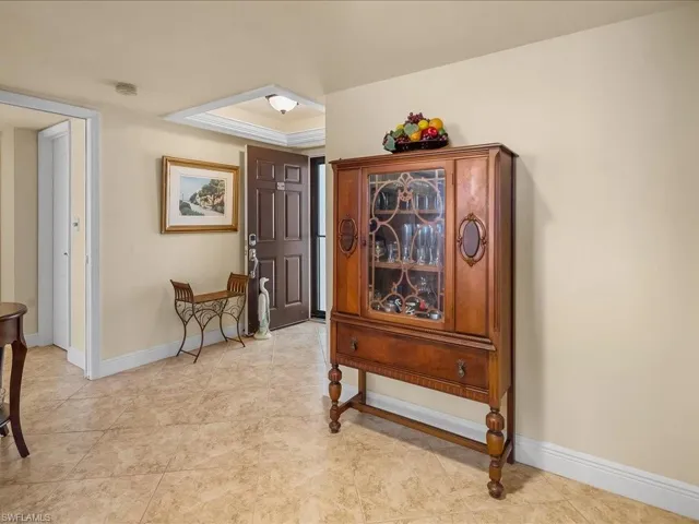 Foyer featuring baseboards and a tray ceiling