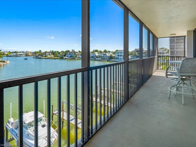 Balcony featuring a sunroom and a bay view