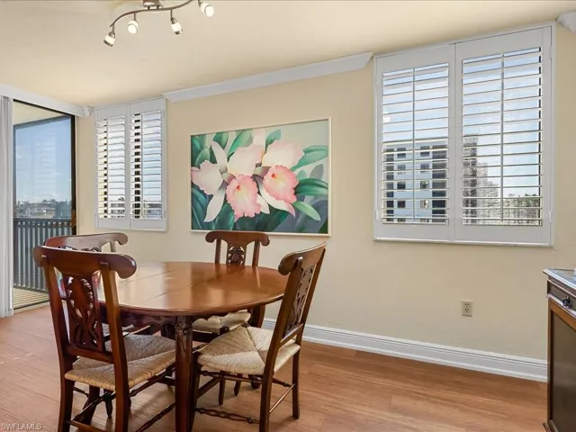 Dining space with balcony access and vinyl wood plank flooring
