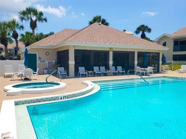 View of swimming pool with a patio area and a community hot tub