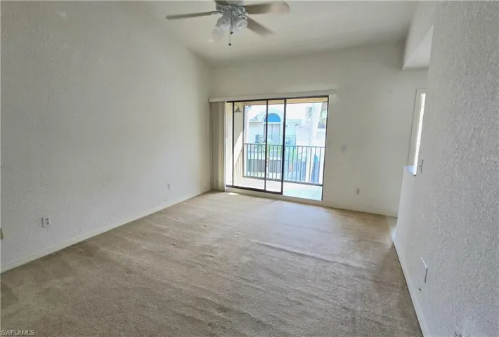 Unfurnished room featuring ceiling fan and light carpet