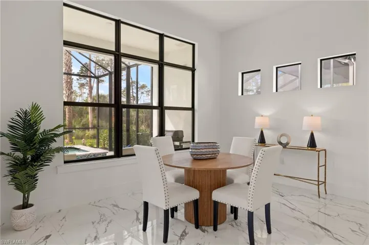 Dining room with baseboards and marble finish floor