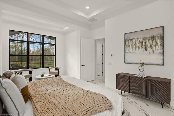 Bedroom featuring recessed lighting, marble finish floor, visible vents, baseboards, and a tray ceiling