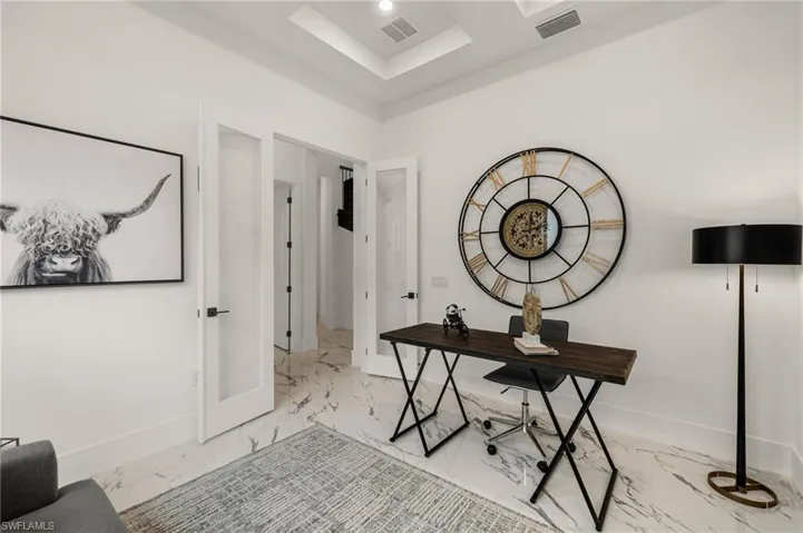 Office with marble finish floor, baseboards, and visible vents