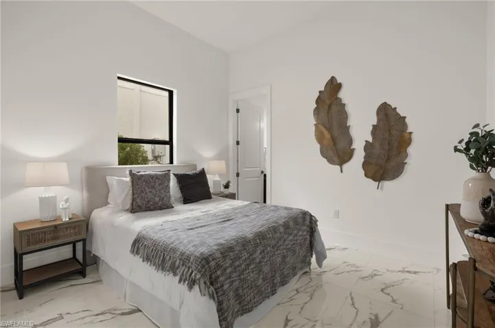 Bedroom with marble finish floor and baseboards