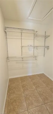Walk in closet featuring light tile patterned floors