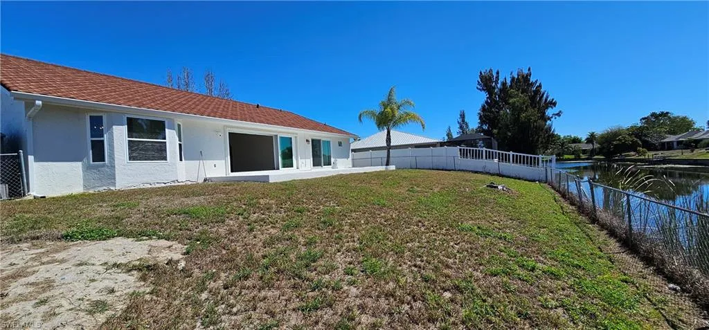 Fenced backyard featuring a water view