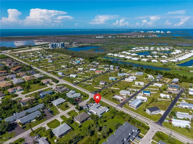 Aerial view of residential area featuring a large body of water