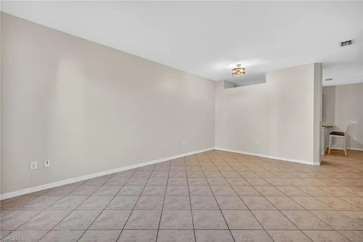 Spare room featuring baseboards and light tile patterned floors