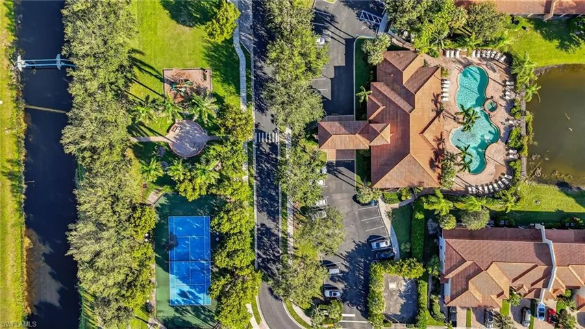 Bird's eye view of a nearby body of water and a pool area