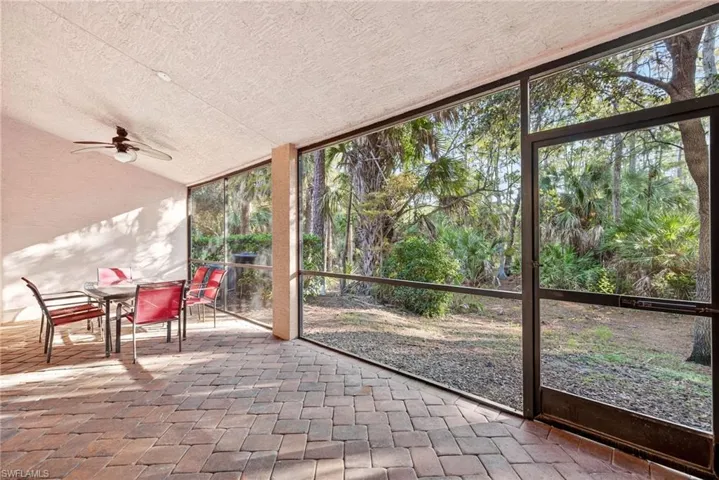 Sunroom / solarium with outdoor dining area, a ceiling fan, and lofted ceiling