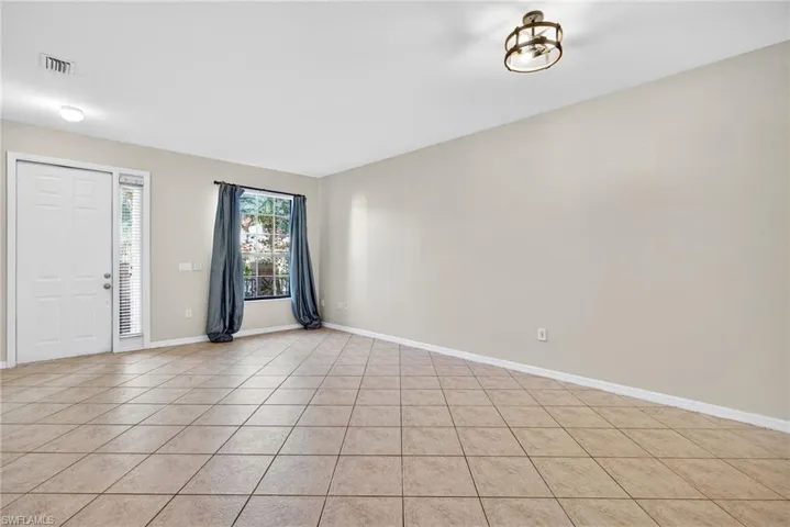 Foyer featuring baseboards and light tile patterned floors