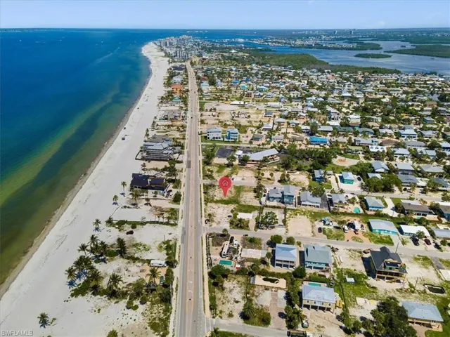 Bird's eye view featuring a water view and a beach view