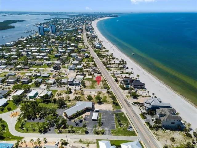 Aerial view with a water view and a view of the beach