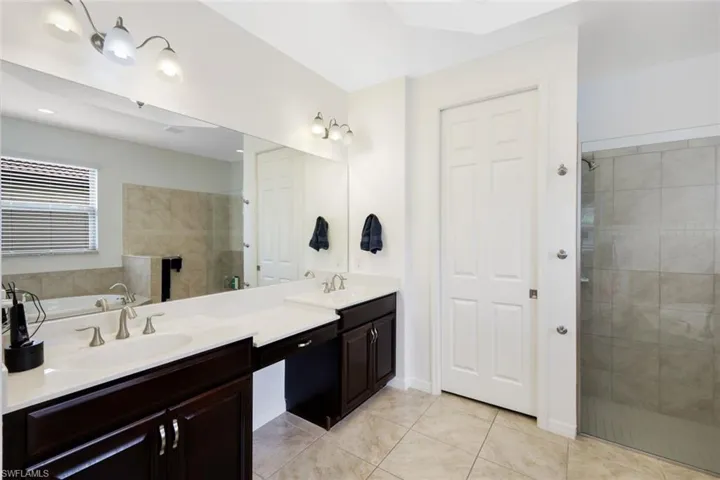 Dual sinks, soaking tub and walk in shower.