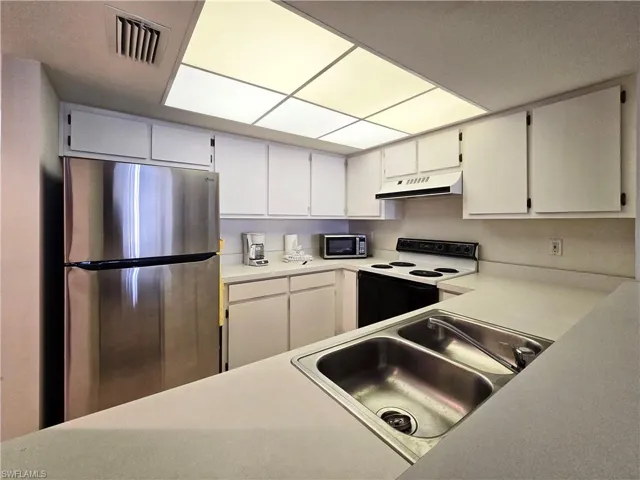 Kitchen with stainless steel fridge/freezer
