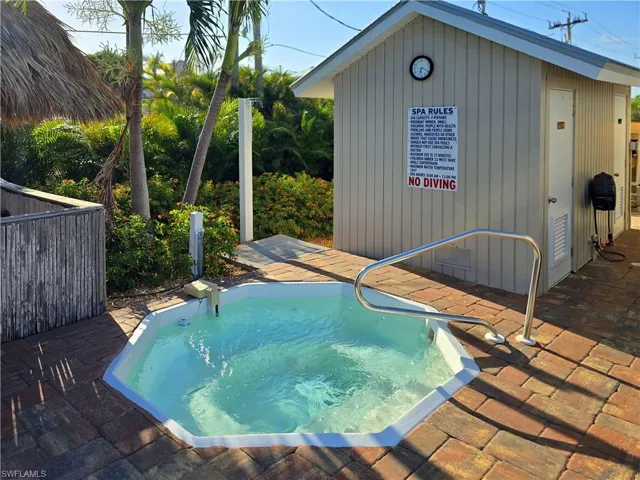 Spa and  outdoor shower next  to the pool