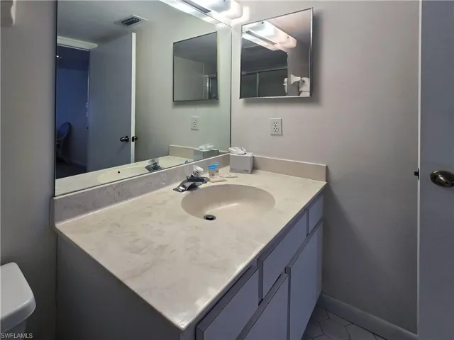 Primary bathroom with vanity and tile patterned floors