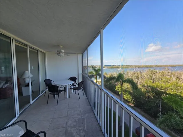 Balcony at the east side featuring a water view