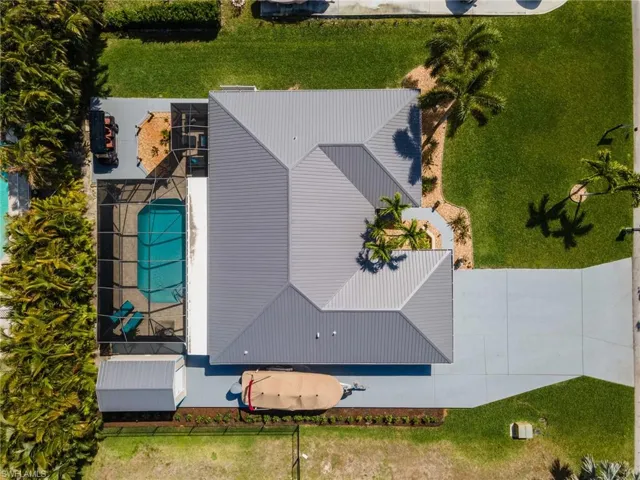 Aerial view of property and surrounding area featuring a pool area