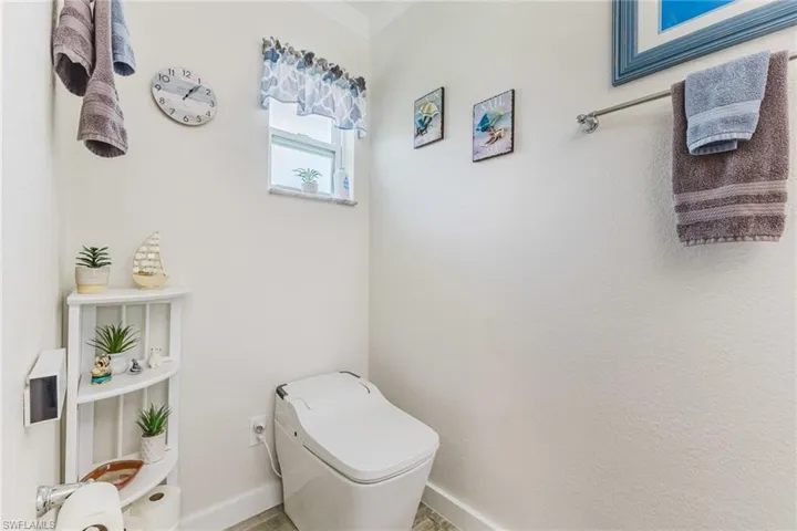 Bathroom with toilet and crown molding