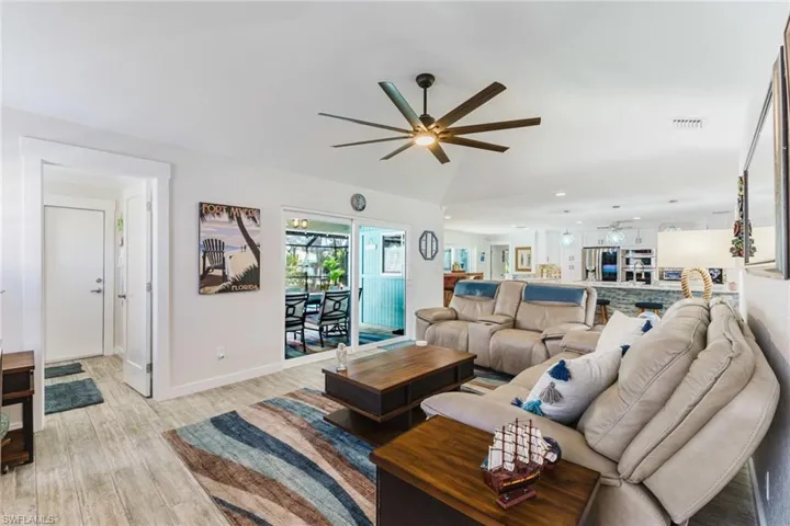 Living area featuring a ceiling fan, light wood-style flooring, and recessed lighting