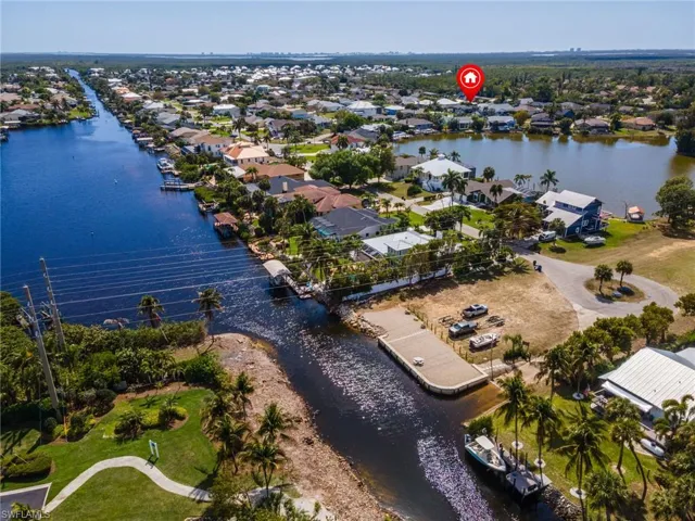 Aerial perspective of suburban area featuring a nearby body of water