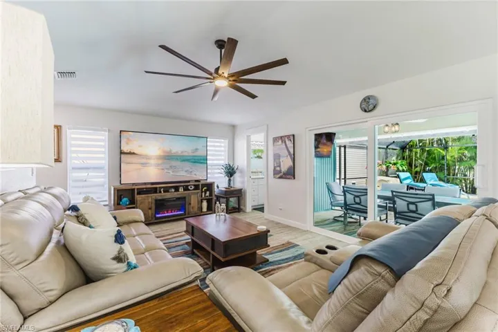 Living area with wood finished floors and ceiling fan