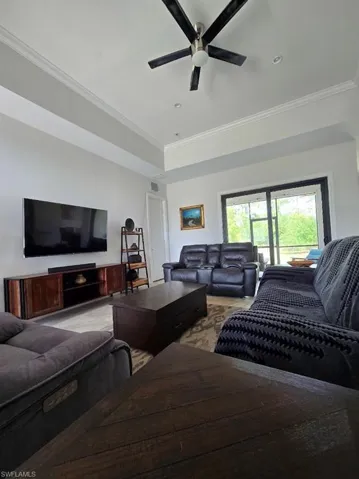 Living area featuring crown molding, recessed lighting, and a ceiling fan