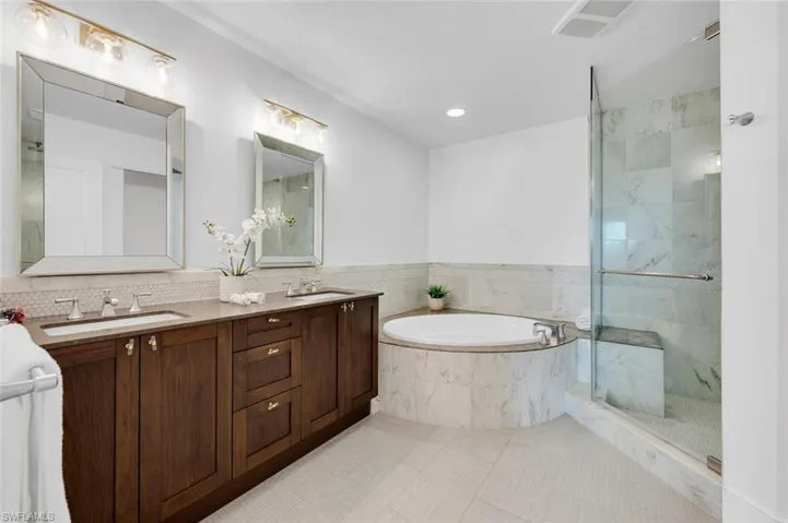 Bathroom featuring vanity, tile patterned floors, and independent shower and large bath tub