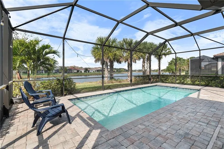 View of pool featuring a water view and screen lanai