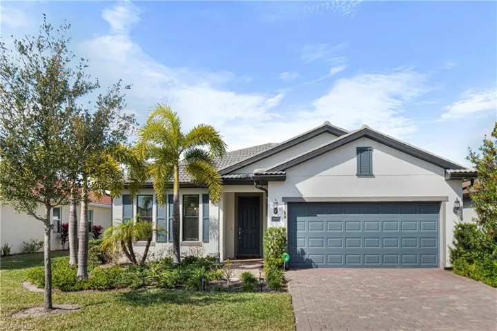 Single story home featuring a garage and tile roof