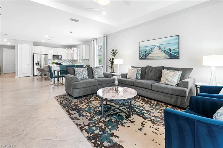Tiled living room featuring a tray ceiling