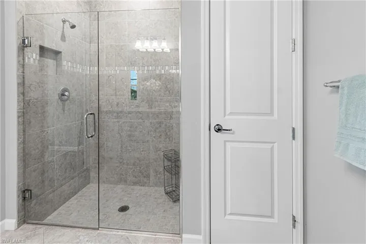 Primary Bathroom featuring a shower with Frameless Glass door