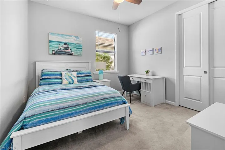 Carpeted bedroom with ceiling fan