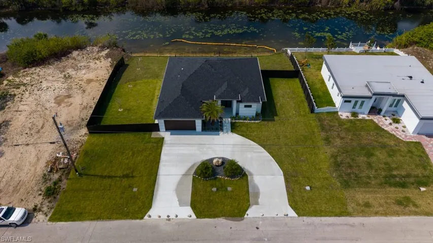 Aerial view of property and surrounding area featuring a nearby body of water