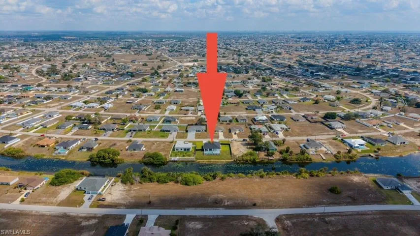 Aerial view of property's location with nearby suburban area