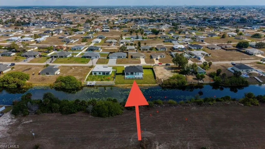 Aerial view of property's location with nearby suburban area and a large body of water