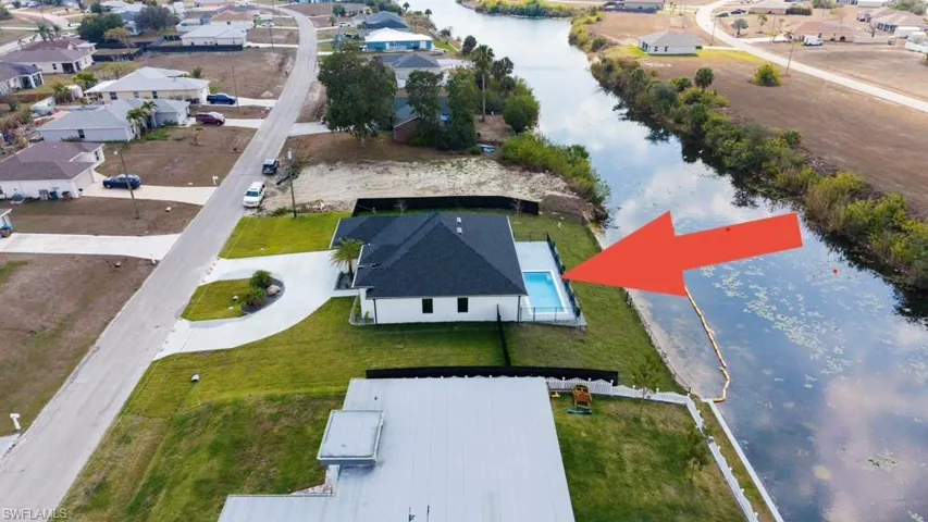 Aerial perspective of suburban area featuring a large body of water