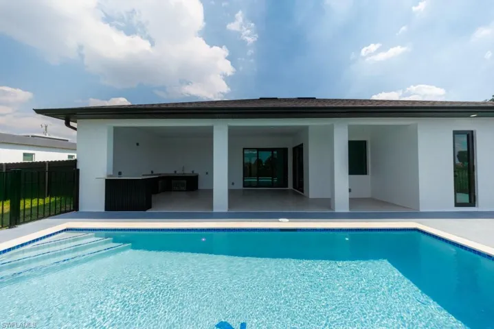 Back of house with a patio and stucco siding